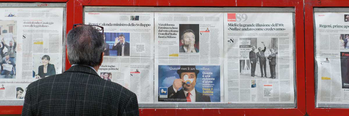 man reading newspaper posted on a public display